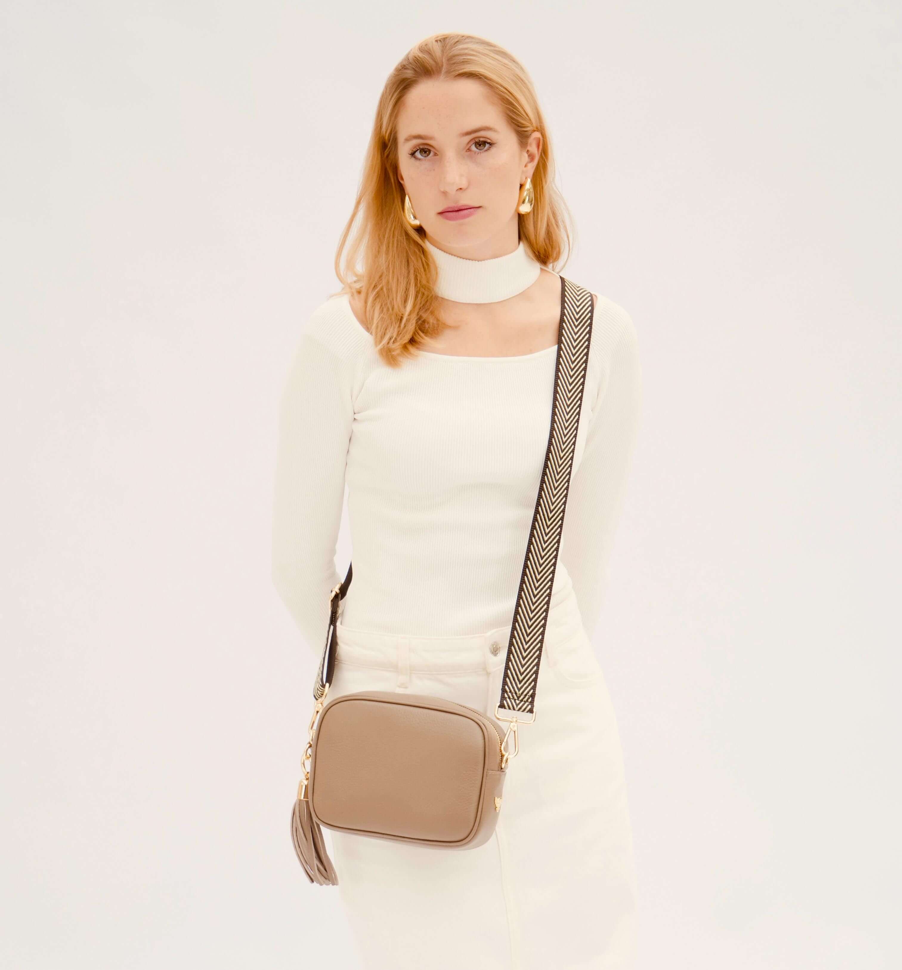The Tassel Latte Leather Crossbody Bag With Black & Gold Chevron Strap