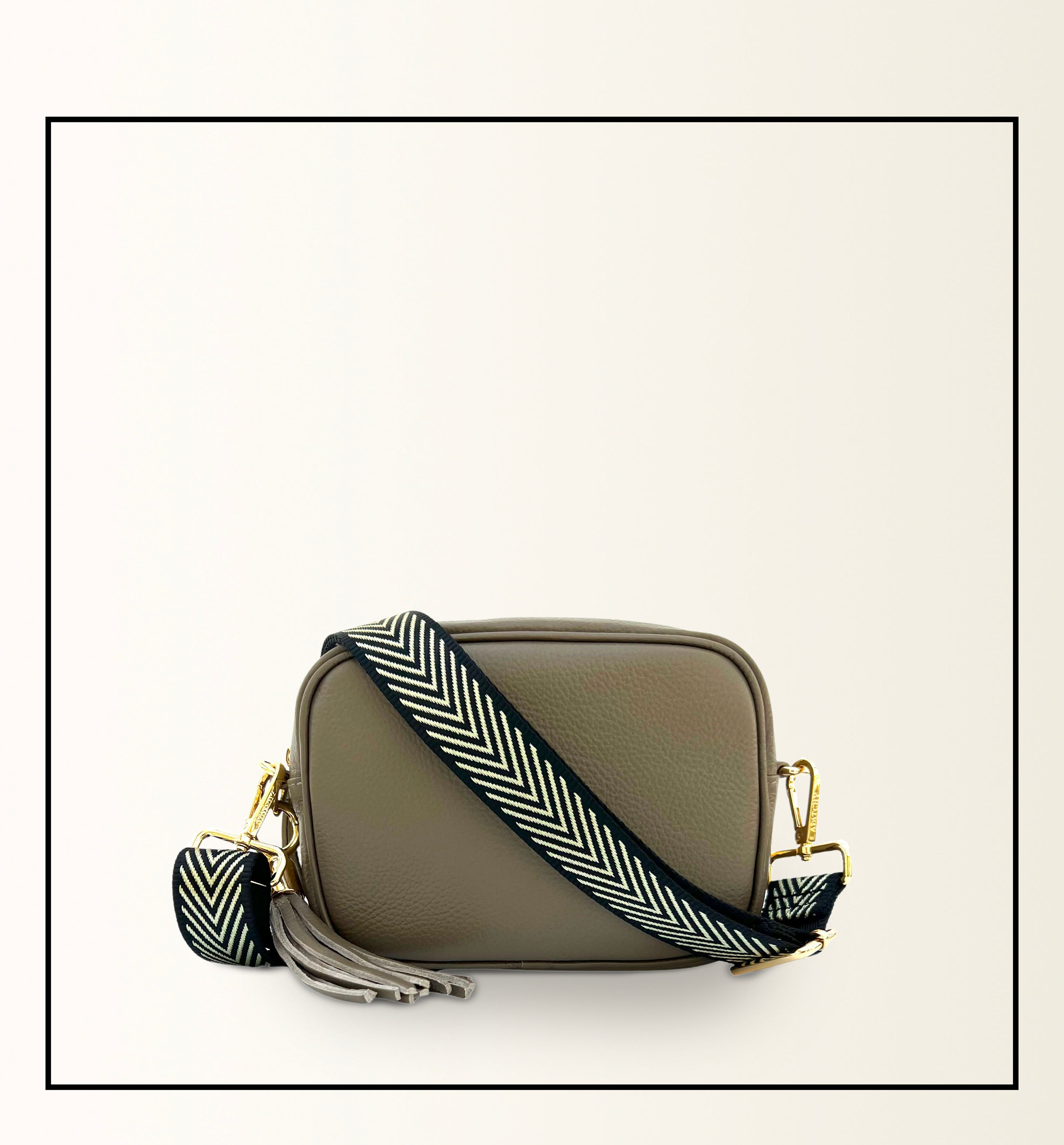 The Tassel Latte Leather Crossbody Bag With Black & Gold Chevron Strap