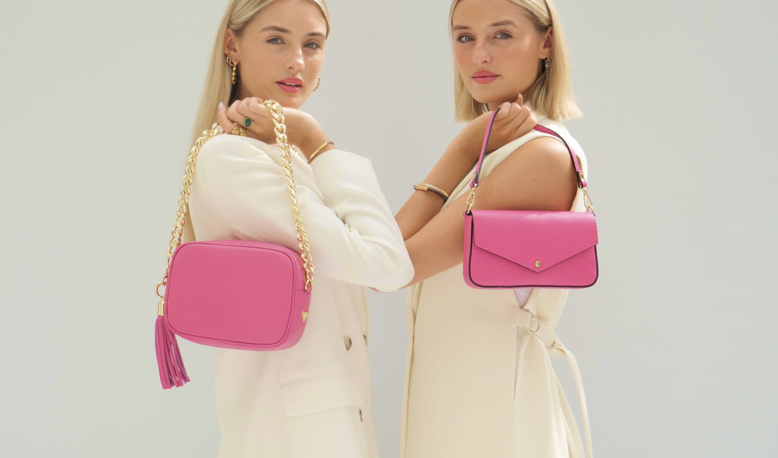 two models holding barbie pink bags