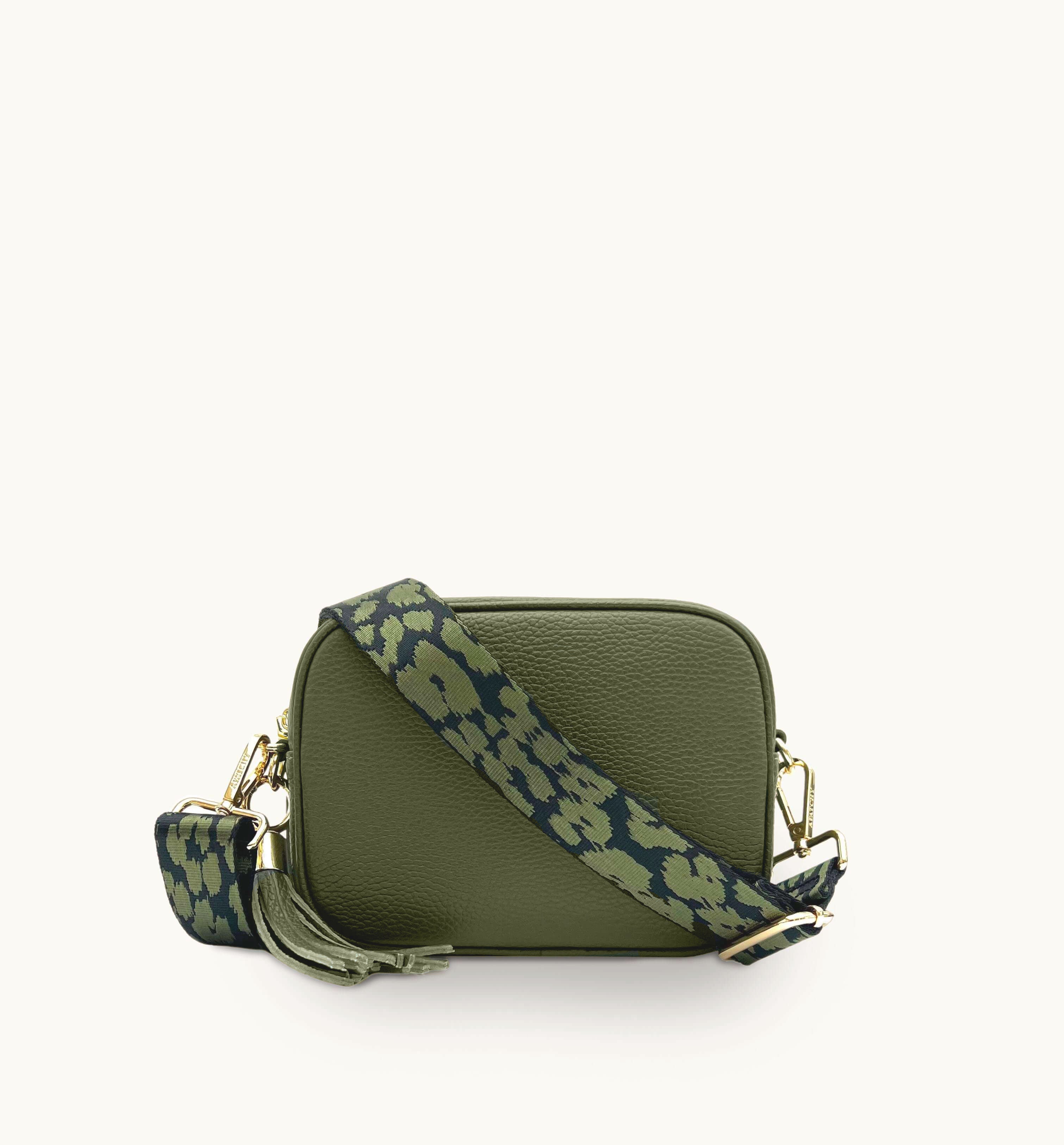 Green crossbody bag with a green cheetah strap on a white background