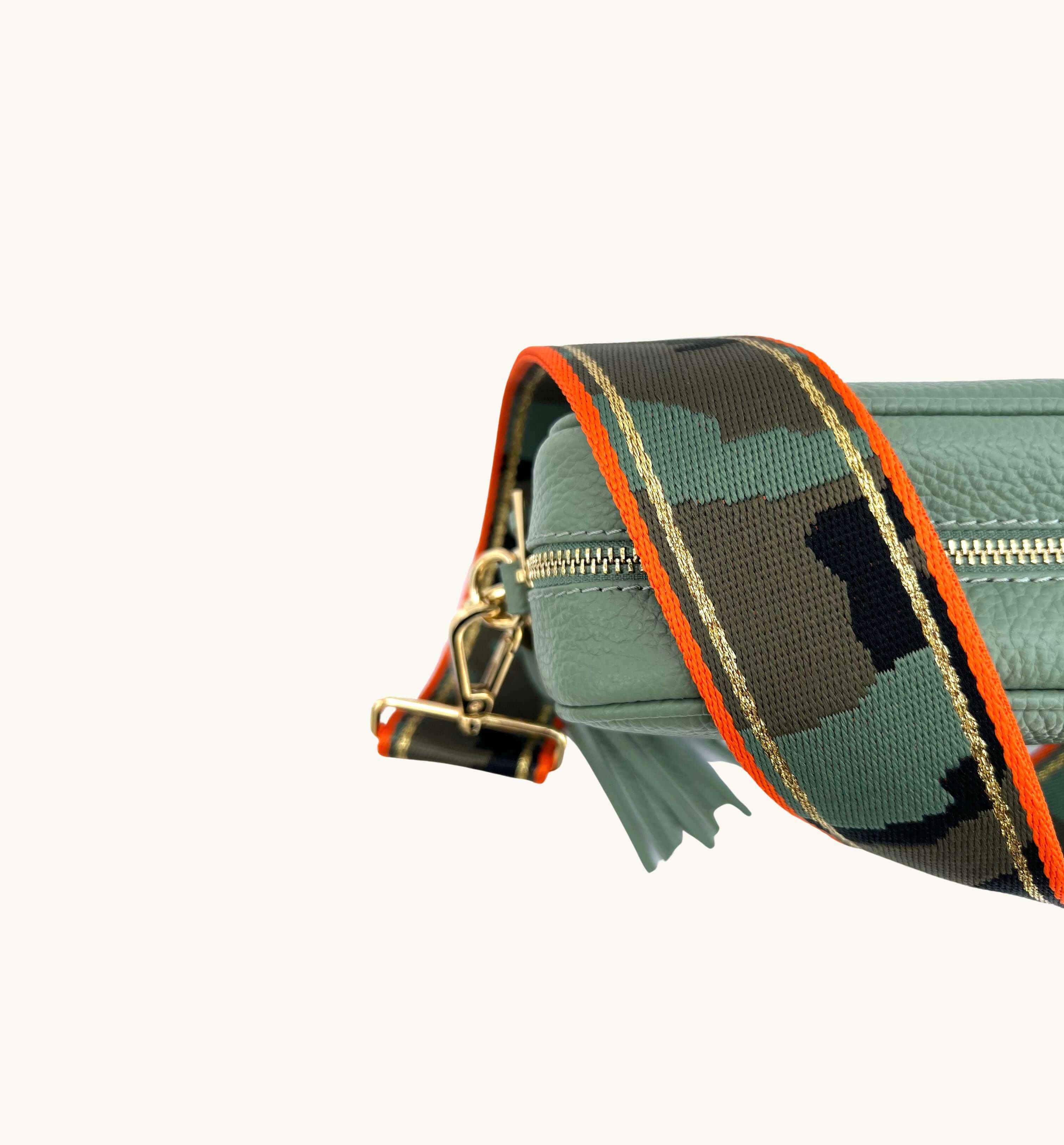 The Tassel Pistachio Leather Crossbody Bag With Orange & Gold Stripe Camo Strap