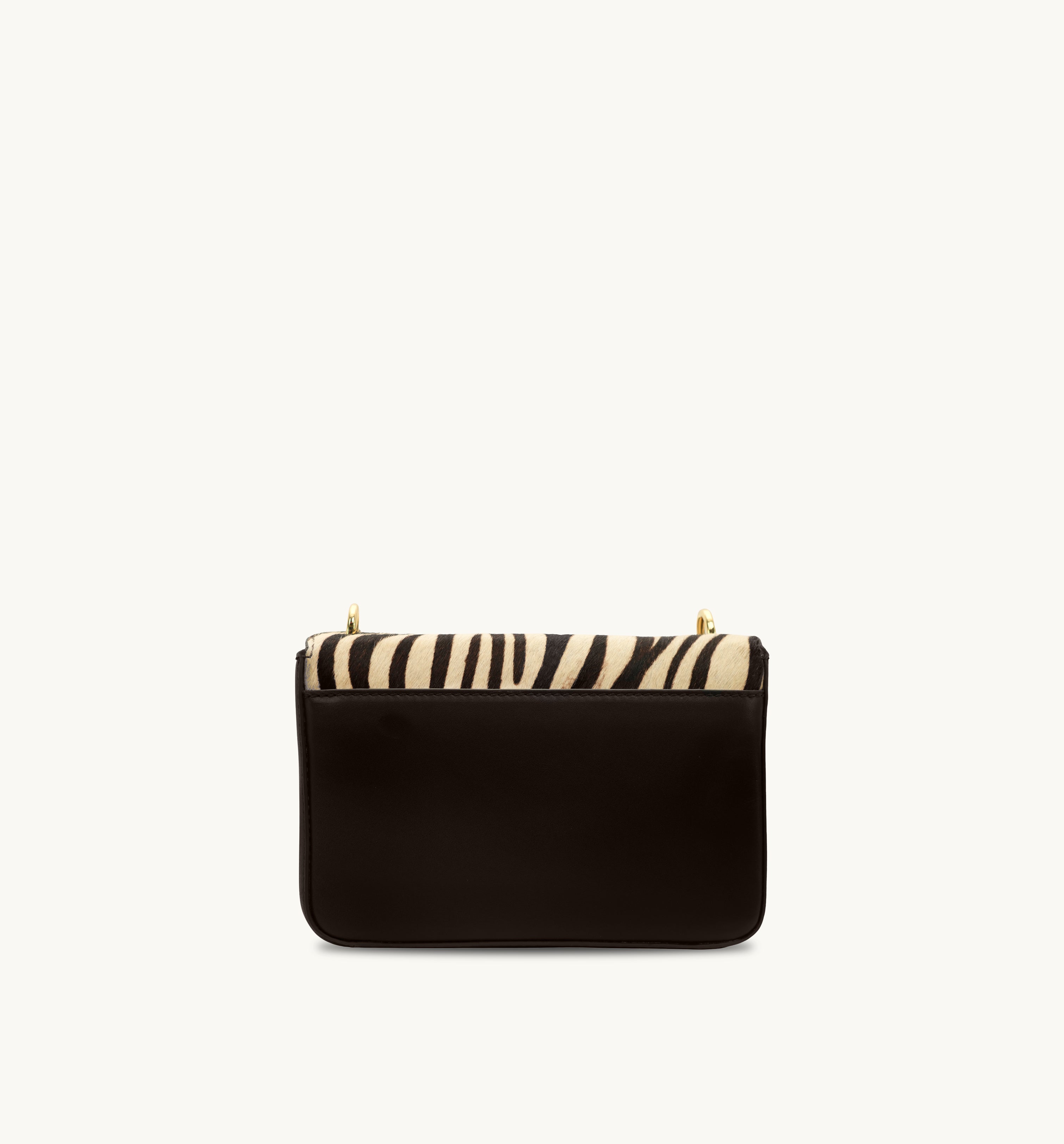 Chocolate clutch with zebra-striped top on a white background
