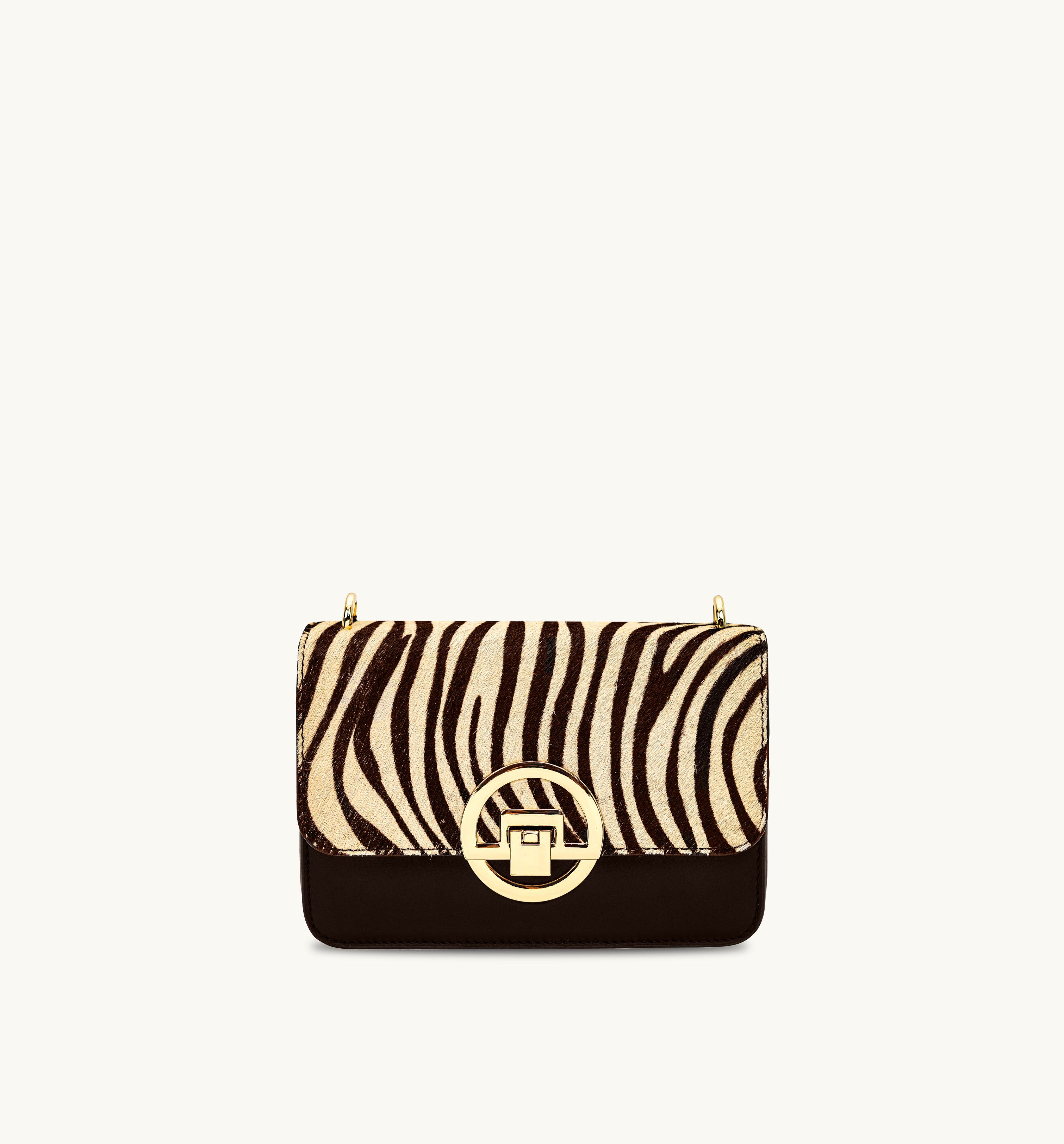 Handbag with zebra print top section and chocolate bottom section on a white background