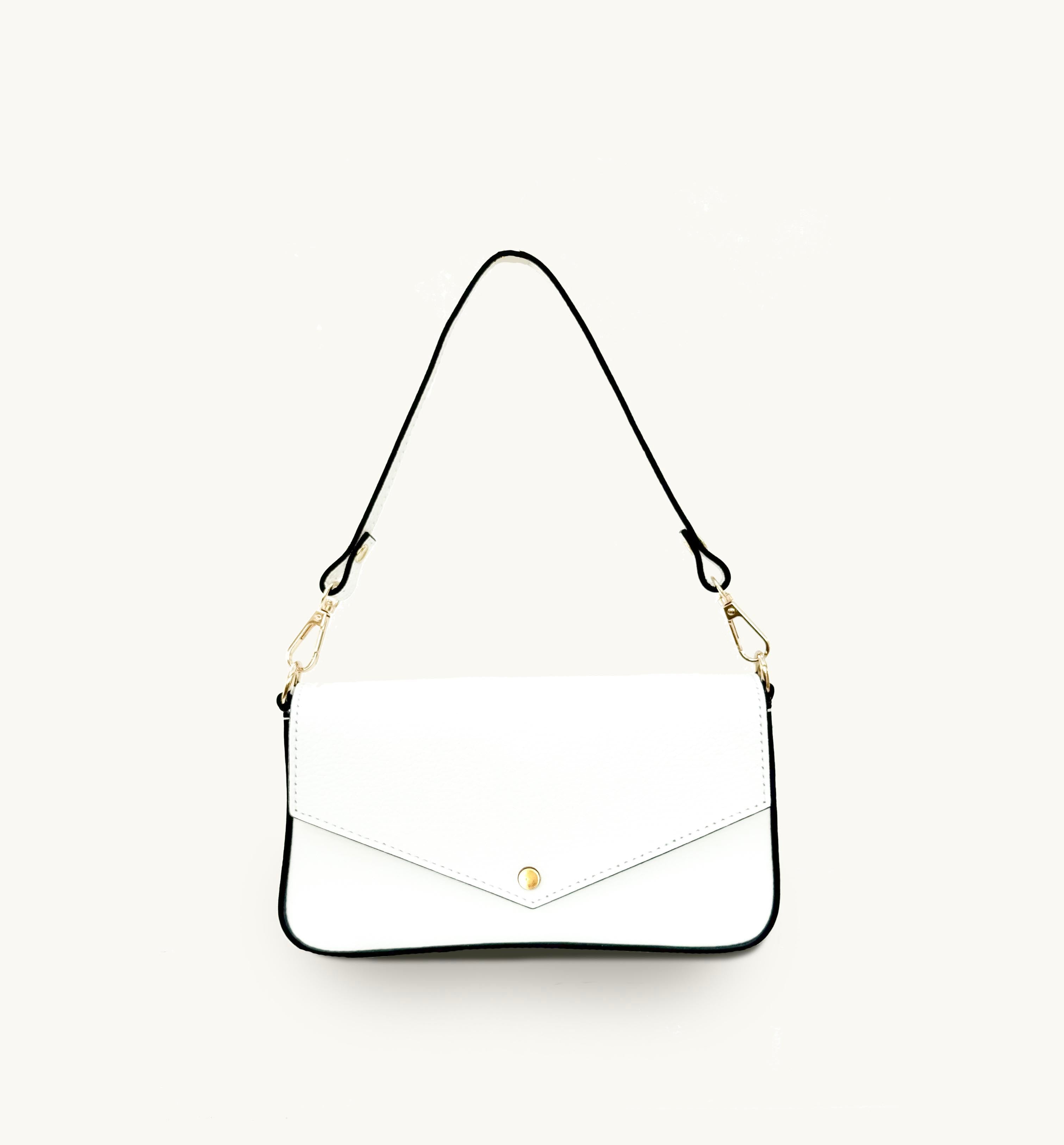 White leather handbag with black trim and gold closure on a white backgroud