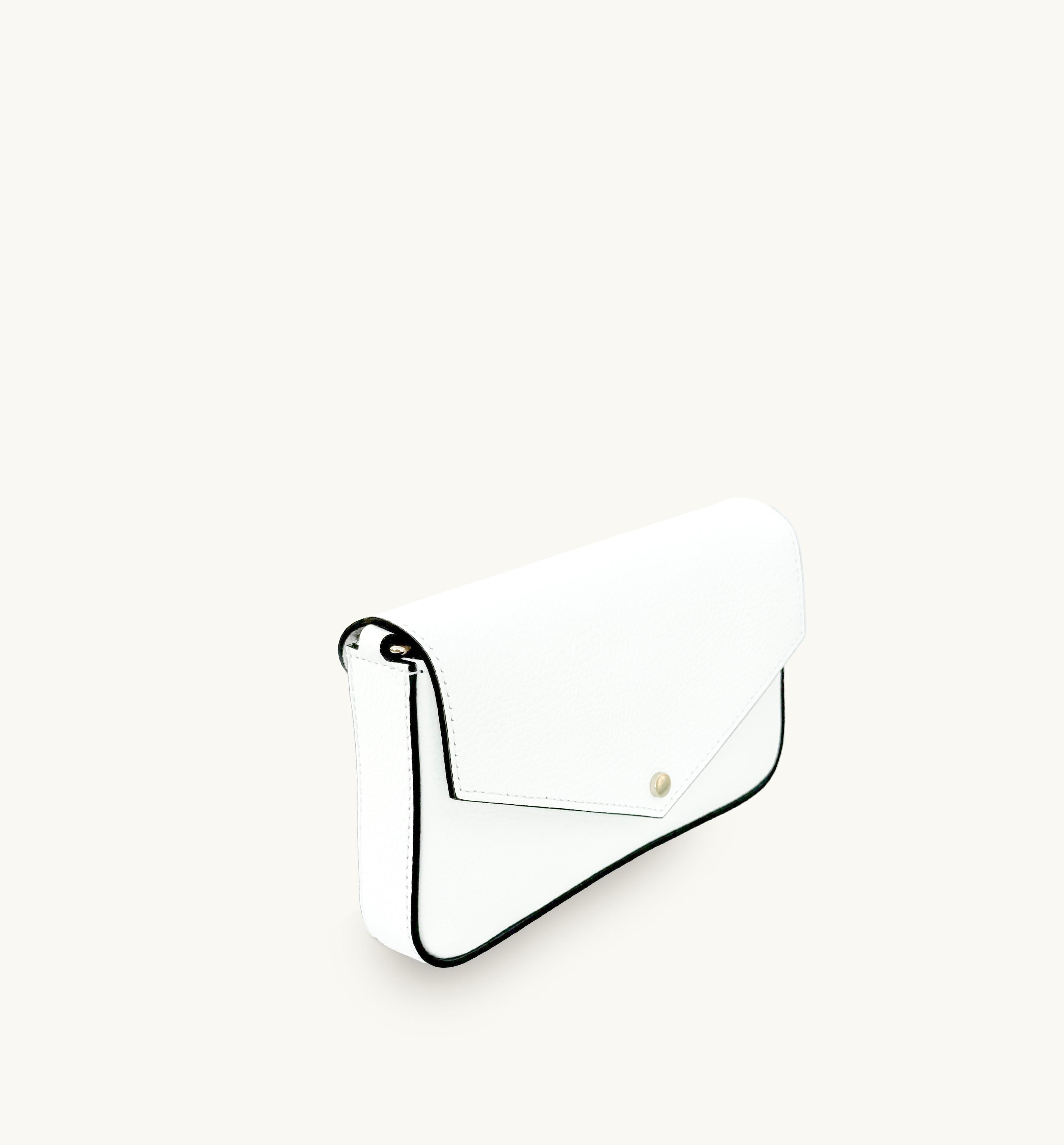 White leather handbag with black rim and gold accents on a white background